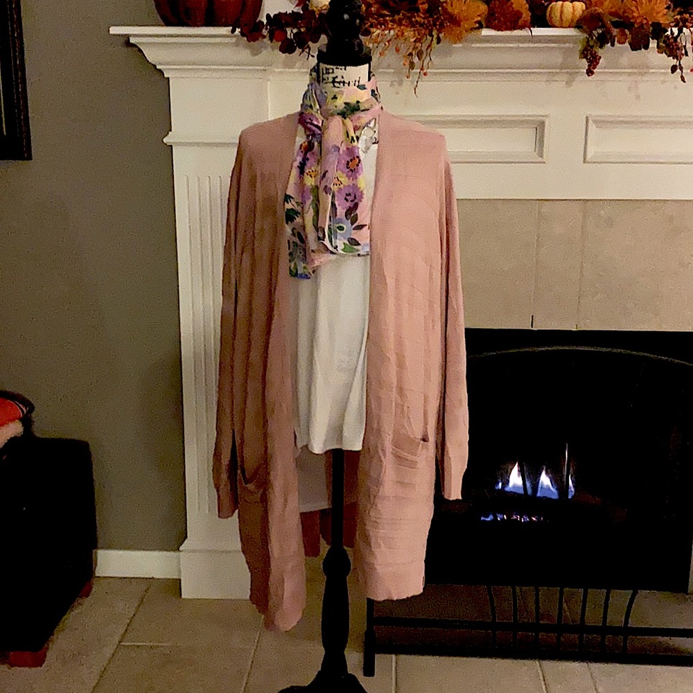 Pink sweater, white shirt and scarf.